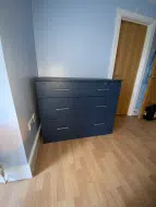 Wide alby blue freestanding drawer chest with standard bar handles, to accompany wardrobes fitted in Preston-on-Tees